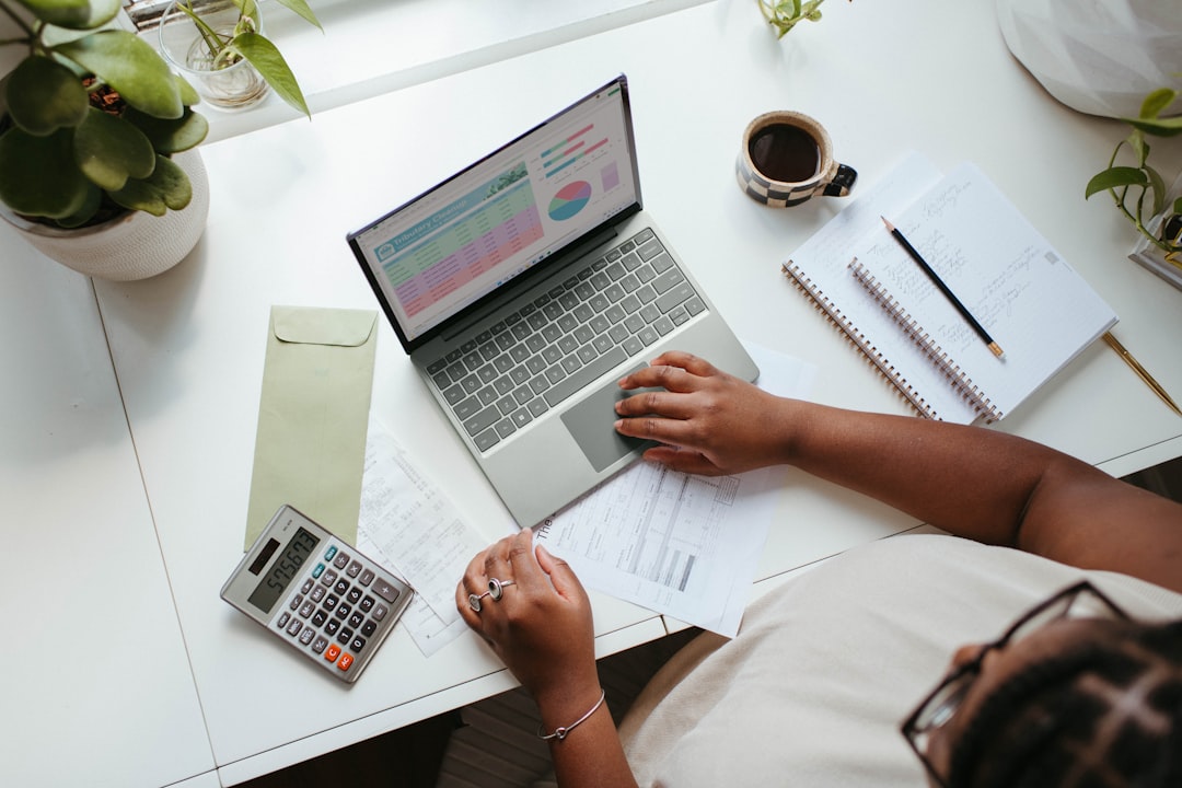 Professional working with documents and a laptop